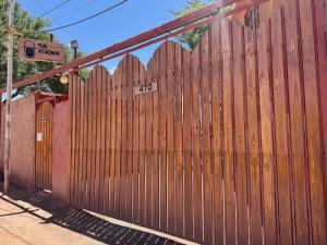 a wooden fence with a sign on top of it at Hotel Turi Atacama in San Pedro de Atacama