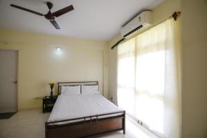 Ένα ή περισσότερα κρεβάτια σε δωμάτιο στο Sunshine Park Homes - Benaulim at Micon +11 φωτογραφίες
