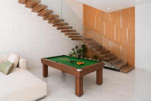a living room with a pool table and a staircase at Villa Ramona, Calme, Luxe et Piscine in Marrakesh