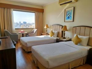 a hotel room with two beds and a window at Imperial Swiss Garden Dhaka in Dhaka +27 photos