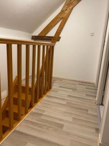 a room with a staircase with wood floors at Villa des marots in Troyes +1 photo