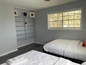 a bedroom with two beds and a window at Private guest rooms & baths in Atlanta +11 photos