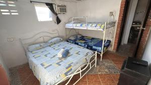 a bedroom with two bunk beds and a window at Hostal #10-33 in Cartagena de Indias
