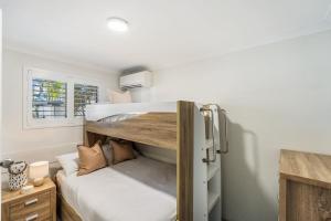 a bedroom with a bunk bed in a room at Absolute Beachfront Apartment 3B in Lennox Head