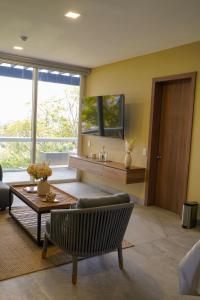 a living room with a couch and a table at Casa de Mar Hotel And Villas in La Libertad