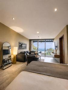 a bedroom with a bed and a living room at Casa de Mar Hotel And Villas in La Libertad +132 photos