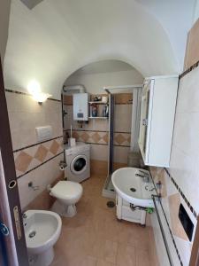a bathroom with a toilet and a sink at Antica Casa Cavaliere in Tramonti