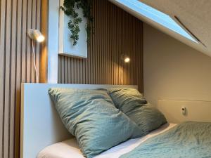 a bed with a large pillow on top of it at Strandloft Pippa in Borkum