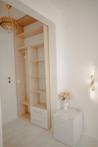 a white closet with a vase of flowers in it at Kiranovi Premium Stay in Bitola