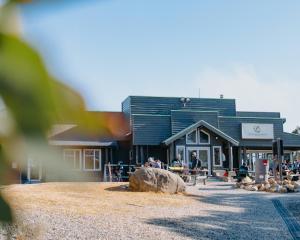 a building with people standing outside of it at Snow Gum Apartment 2 in Baw Baw Village
