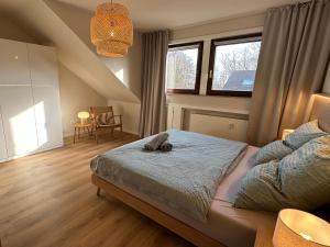 a bedroom with a bed with a stuffed animal on it at Strandloft Pippa in Borkum +23 photos
