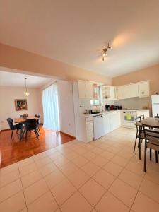 a kitchen and dining room with a table and chairs at Mega Panorama Apartments in Paleo Tsifliki