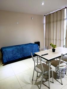 a room with a table and chairs and a bed at Complejo Carrodilla4 in Ciudad Lujan de Cuyo