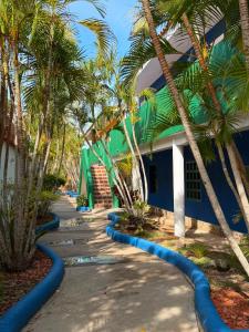 a blue building with palm trees in front of it at Isla de margarita in Pampatar
