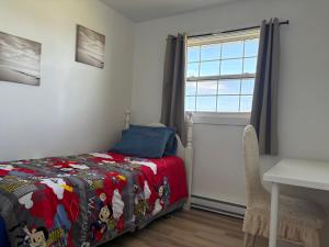 a bedroom with a bed and a window and a desk at Three bedrooms cozy home in Sydney