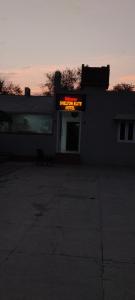 a building with a lit up sign on top of it at Shelton Elite Hotel in Multan