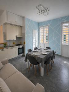 a kitchen and dining room with a table and chairs at Alassio Attico con Terrazza AC WIFI in Alassio +8 photos