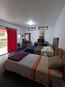 a bedroom with two beds and a television in it at Casa León in Orizaba