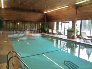 a large swimming pool in a large building at Ramada by Wyndham Kelowna Hotel & Conference Center in Kelowna