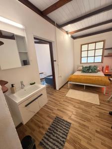 a bedroom with a bed and a sink and a mirror at Fare Maeva in Paopao