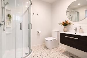 a bathroom with a shower and a toilet and a sink at Modern Mountain View Retreat, 2 Bedroom Stay in Frankton +9 photos