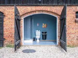 a brick garage with a toilet in it at Camping Szelągówka in Sorkwity +28 photos