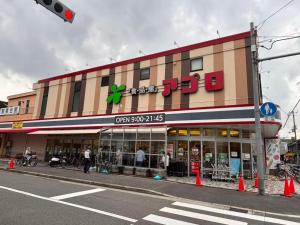 a store on a street corner with a traffic light at 颯House 3-4 in Osaka