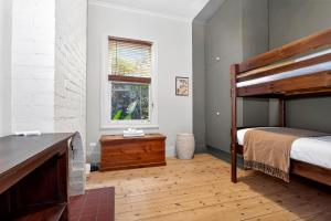 a bedroom with a bunk bed and a window at Ada Art Deco by Host Solutions Hutt St, Heritage in Adelaide