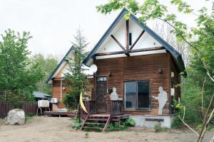 a small house with a gambrel roof at Kussharoko Artemina Deer in Teshikaga
