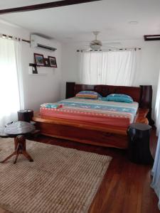 a bedroom with a large bed with a wooden frame at PuertoViejo in Puerto Viejo +29 photos