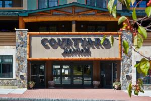 a building with a sign that says, "downtown" on it at Courtyard by Marriott Lake George in Lake George