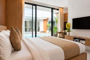 a bedroom with a large bed and a television at Hotel K Seminyak in Badung
