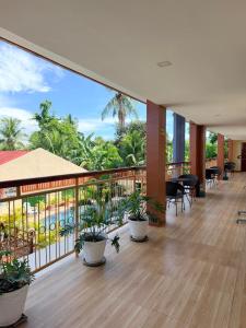a room with a balcony with potted plants at Rufana Suites in Moalboal