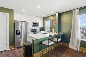 a kitchen with a counter and a refrigerator at The Bavarian Inn 6 Chic 1 BDR in Covington