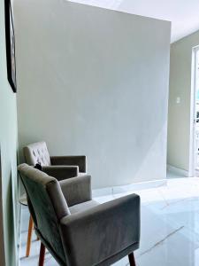 a living room with a chair and a couch at Recanto Sole Luz in Piranhas +14 photos