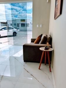 a living room with a couch and a table at Recanto Sole Luz in Piranhas