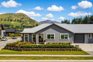 a house with a mountain in the background at Spacious Modern Retreat, Near Shops & Cafes in Queenstown