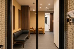 a hallway with a couch and a dining room at Sugamo Winco Residence 新宿まで電車14分 巣鴨駅徒歩3分 光wifi エレベーター 商店街徒歩4分 in Tokyo +58 photos