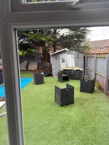 a view from a window of a yard with chairs at Hunters lodge in Blackpool