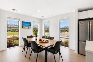 a kitchen and dining room with a table and chairs at Spacious Modern Retreat, Near Shops & Cafes in Queenstown