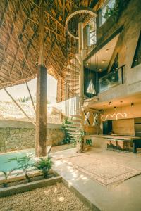 a building with a pool in the middle of it at Happiness Kulambo Villa El Nido in El Nido