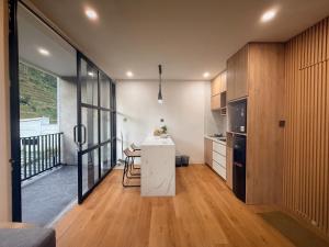 a kitchen with a white island in a room at Singgah Sejenak Dieng in Diyeng
