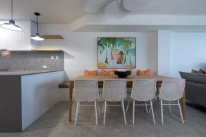 a kitchen and dining room with a table and chairs at Beachfront Villa in Coolum Beach