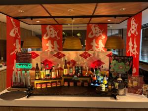 a bar with a lot of bottles of alcohol at Super Hotel Kofu Showa Inter in Showa