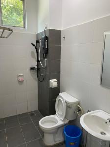a bathroom with a shower and a toilet and a sink at PL Homestay 2 in Padang Lembu +5 photos