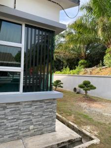a house with a window on the side of it at PL Homestay 2 in Padang Lembu