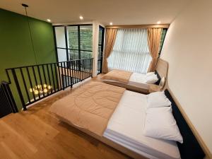 a large bed in a room with a balcony at Singgah Sejenak Dieng in Diyeng