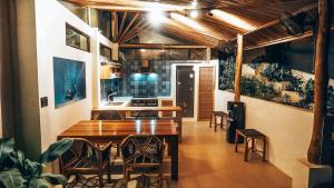 a kitchen with a wooden table and some chairs at Bliss Villa By Happiness Philippines in El Nido