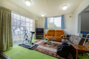 a living room with a couch and a table at ペンションレークサイド in Otsu