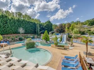 a pool with lounge chairs and a water park at Cottage, animaux acceptés - 6 pers. - API-1-52-2931 in Lamonzie-Montastruc